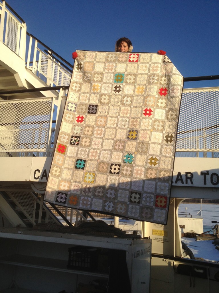 Me, showing off my quilt from the upper level of the Arnie J. Richter ferry boat, Washington Island, WI. It was about 10 degrees that day. 