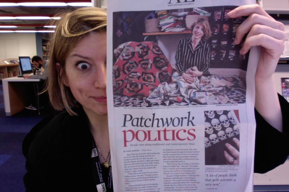 Me in the library at SAIC with the paper today! Photo: Me and the computer.